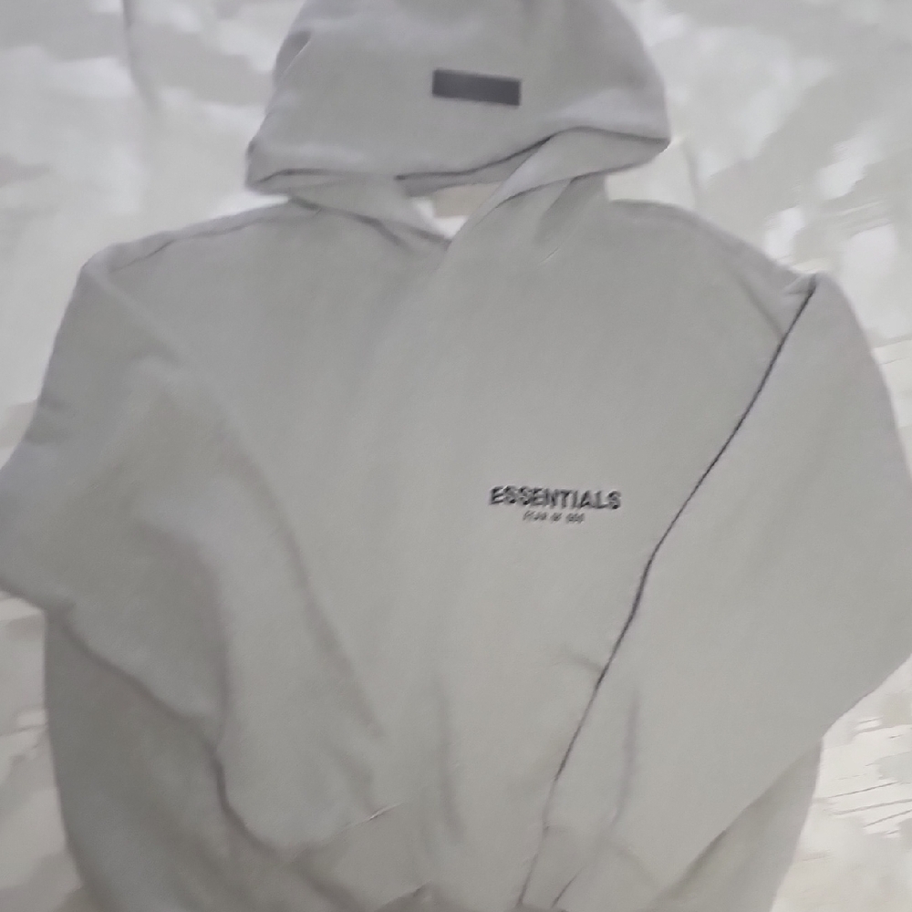 Fear of God Essentials Light Oatmeal Pullover Hoodie.